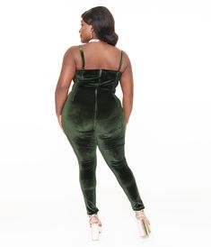 Inspired by the 1970s fashion, this plus size jumpsuit brings retro vibes to your modern wardrobe. The beautiful dark green color is both eye-catching and flattering on all body types. With adjustable spaghetti straps, you can easily customize the fit to ensure maximum comfort throughout the day. The included belt cinches at the waist, enhancing your curves and adding a touch of elegance to this already fabulous piece. Crafted from luxurious velvet fabric, it offers a soft and velvety feel against your skin while exuding an air of sophistication wherever you go..Available in sizes XS-5X while supplies last. | Unique Vintage Plus Size 1970S Dark Green Velvet Jumpsuit | Size 2X/18 Green Velvet Plus Size Dress, Brown Velvet Overalls, Green Velvet Bodysuit, Green Velvet Jumpsuit, Plus Size Velvet Tracksuit, 70s Velvet Jumpsuit, Dark Green Velvet, Vintage Plus Size, Dark Green Color