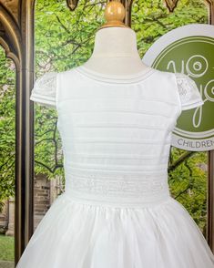 A dainty yet classical first communion gown for girls made with lightweight organza in natural white with distinguished laces and pleats. The dress has buttons on the back for closure and a bow. Dry clean Made in Spain Final sale, no exchanges nor returns will be accepted Fitted First Communion Dress, Fitted Lace First Communion Dress, Classic Dresses With Fitted Bodice For First Communion, Fitted Dress With Pleated Bodice For First Communion, Lace First Communion Dress, Classic White First Communion Dress, Baptism Dress With Lace Bodice For Confirmation, Classic Fitted First Communion Dress, First Communion Dress With Ruffles And Fitted Bodice