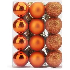 orange and gold christmas ornaments in a clear box