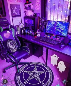 a desk with a chair and computer on it in front of a halloween themed wall