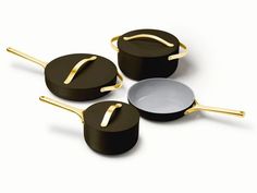 three pots and two pans with gold handles