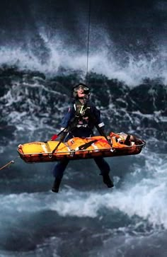 a rescue worker in the middle of a large body of water holding onto a rope