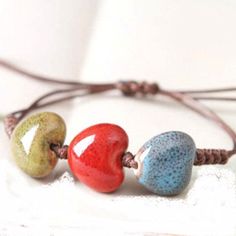 three different colored beads on a string