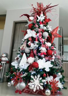 a christmas tree decorated with red, white and silver ornaments