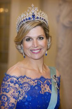 a woman wearing a tiara and smiling at the camera