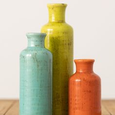 Ceramic bottle set measuring 5", 7.5" and 10" accordingly. All three colorful pieces feature 1" openings perfect for a favorite stem or to simply stand alone. Over the last 55 years, Sullivans has become an industry leader in home decorations. Our brand is rooted in tradition while incorporating modernized trends to keep your home looking up to date with timeless style. Here at Sullivans, we pride ourselves on creating product designs focused on quality and value, ensuring that our customers hav Colorful Tablescapes, Bottle Shapes, Flower Desktop Wallpaper, Teal Vase, Farmhouse Vase, Clay Artists, Bags Sewing, Striped Vase, Colored Vases