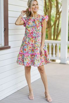 Say hello to this colorful floral babydoll dress with its charming rickrack detailing! Bursting with stunning colors, this dress is sure to brighten your day. The ruffled cap sleeves add a touch of femininity, making it perfect for any occasion. Pair it with sneakers for a fun day out or dress it up with heels for a chic, sophisticated look! Round neckline Button keyhole back Ruffled cap sleeves Colorful floral print Rickrack detailing Babydoll cut No stretch Baileigh is wearing the small. Playful Ruffle Sleeve Dress With Floral Print, Playful Floral Print Dress With Ruffle Sleeves, Playful Ruffled Floral Dress For Spring, Multicolor Flutter Sleeve Dress With Ruffle Hem, Multicolor Flowy Ruffle Sleeve Dress, Multicolor Flowy Dress With Ruffle Sleeves, Multicolor Flutter Sleeve Dress With Ruffles, Multicolor Short-sleeve Floral Dress With Ruffles, Multicolor Floral Dress With Ruffles And Short Sleeves