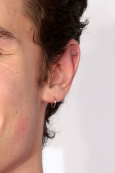 a close up of a person with ear piercings