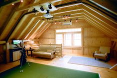 an attic with wood paneling and green carpeted flooring is shown in this image