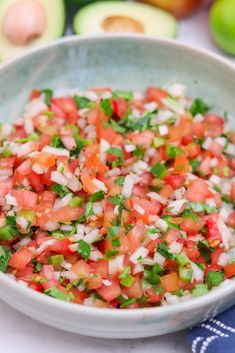 a white bowl filled with salsa and tortilla chips on top of a table