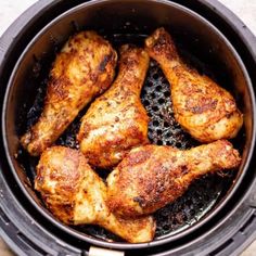 chicken legs in an air fryer with text overlay