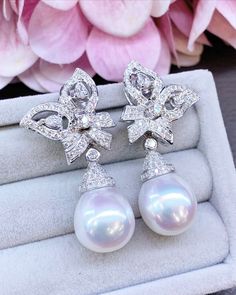 We are presenting you a HUGE pair of CHANDELIER, Genuine, PURE White South Sea Pearls, extremely FINE AA+, LUSTROUS and Rare! Accenting the 2 pearls are 156 pieces of F/VS Natural diamonds, weighting a total of 1.96 carats. Set in fabulously designed 18K solid white gold earrings. Perfect dangling style! Perfect for formal events and cocktail parties!  ONLY ONE ITEM AVAILABLE!! NO DUPLICATES!! WHAT YOU SEE IN THE PICTURES IS WHAT YOU WILL GET SOLIDLY HANDCRAFTED EARRINGS! SUGGESTED RETAIL VALUE: Luxury Pear-shaped Diamond Earrings For Evening, Luxury Drop Pearl Earrings, Luxury White Gold Drop Pearl Earrings, Luxury Drop Pearl Earrings For Formal Occasions, Luxury Drop Pearl Earrings For Formal Events, Luxury Pear-shaped Pearl Earrings, Luxury White Pear-shaped Pearl Earrings, Luxury Pear-shaped Earrings For Evening, Luxury White Pear-shaped Bridal Earrings