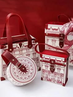 three pieces of red and white paper with designs on them, including a tote bag