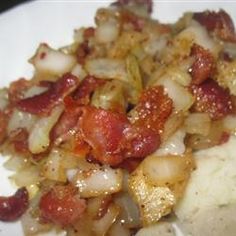 a white plate topped with meat and veggies