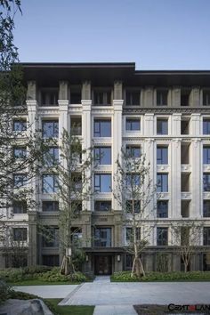 an apartment building with many windows and trees