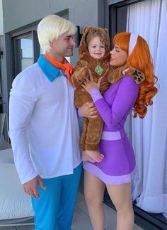 the man and woman are dressed up as disney characters