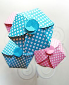 four origami cupcakes with polka dots on them