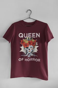 🖤 Product Details:- 100% Soft Ring-Spun Cotton- Light fabric that runs true to size- Unisex- Made in the USA 🇺🇸 🖤 Description:Unleash your inner Queen Of Horror this Halloween with our Spooky Halloween T-Shirt. Embrace the macabre with a hauntingly beautiful undead woman, adorned with a regal crown and a crimson floral wreath. This frightfully fabulous tee is perfect for those who love all things eerie and enchanting. Whether you're planning to rule the Halloween party or simply want to add Hauntingly Beautiful, Soft Ring, Halloween T Shirt, Cotton Lights, Spooky Halloween, Halloween Tshirts, Halloween Party, Light Fabric, Clothing Brand