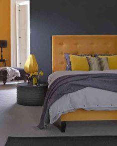 a bedroom with yellow and gray decor in it