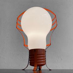 an orange and white light bulb sitting on top of a table