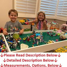 two children are playing with legos in a playroom that is filled with toys