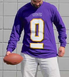 Curio Wellness is here to play! Celebrate game day every day when you wear this bold purple sport-style long sleeve shirt. Sporty Long Sleeve Top For Game Day, Game Day Long Sleeve Tops With Team Logo, Long Sleeve Tops With Team Logo For Sports Events, Collegiate Long Sleeve Tops For Sports Events, Sports Fan Long Sleeve Top With Team Logo, Long Sleeve Tops With Team Name For Sports Events, Casual Purple Game Day Top, Sports Event Long Sleeve Tops With Team Name, Long Sleeve Sports Event Tops With Team Name