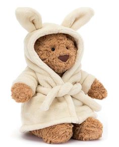 a brown teddy bear wearing a white robe and bunny ears on it's head