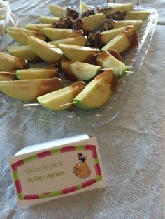 there are many pieces of fruit on the table with a name tag next to it