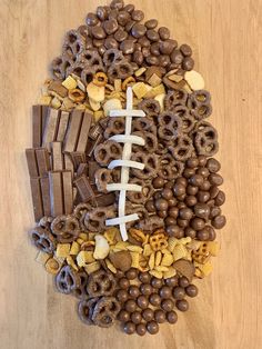 a football made out of cereal and chocolates on top of a wooden table next to other snacks