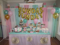 a table topped with lots of desserts and balloons next to a sign that says sunday