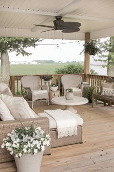 a porch with wicker furniture and white flowers