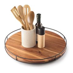 wooden utensils and bottles are on a tray