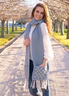 a woman is wearing a scarf and boots