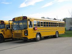 two yellow school buses parked next to each other