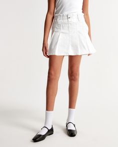 High rise mini skort in a soft denim fabric, with on-trend pleating details, built-in shorts, pockets and a pull-on style elasticated waistband for maximum comfort. White Skirt With Belt, Pleated White Skirt, Pleated Denim, Denim Skort, Skirt With Belt, Rompers Online, Front Tie Shirt, Abercrombie Kids, Active Leggings