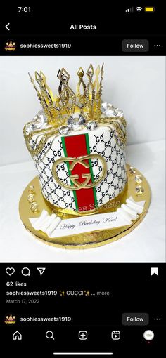 a cake that is decorated with gold and red ribbon on top of a white table