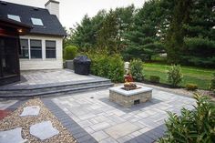 an outdoor patio with stone steps and landscaping