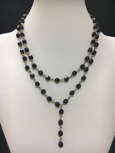 Grace the stunning double strand black bead necklace with single long strand drop.  Perfect for any special occasion! Cheap Elegant Double Strand Beaded Necklaces, Elegant Beaded Chain Lariat Crystal Necklace, Elegant Lariat Crystal Necklace With Beaded Chain, Elegant Crystal Lariat Necklace With Beaded Chain, Elegant Multi-strand Crystal Necklace For Parties, Elegant Multi-strand Crystal Necklaces For Parties, Black Double Strand Faceted Beads Jewelry, Elegant Black Drop Necklace, Elegant Beaded Drop Necklace