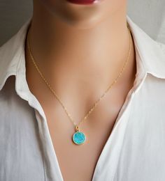 Add some bright color to your look this necklace! Featuring a polished Turquoise slice on your choice of a sterling silver or 14k gold filled chain, this gemstone is believed to bring balance and serenity to its wearer. Turquoise is also the birthstone for December!Stone Size: average 12mm (.47") Modeled Size: 16 Inches Turquoise Necklace With Delicate Chain For Gift, Everyday Turquoise Jewelry With Adjustable Chain, Dainty Turquoise Round Pendant Jewelry, Turquoise Sterling Silver Jewelry With Delicate Chain, Turquoise Necklace With Coin Pendant As A Gift, Turquoise Coin Pendant Jewelry As Gift, Blue Coin Pendant Jewelry As Gift, Blue Coin Pendant Jewelry For Gifts, December Stone