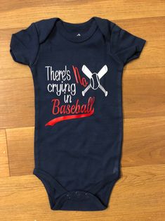 there's no crying in baseball baby bodysuit on the floor with wood floors