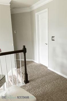 an empty room with white walls and carpet