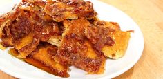 a white plate topped with fried food on top of a wooden table