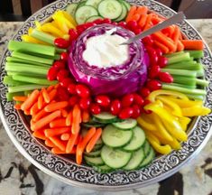 a platter filled with vegetables and dip