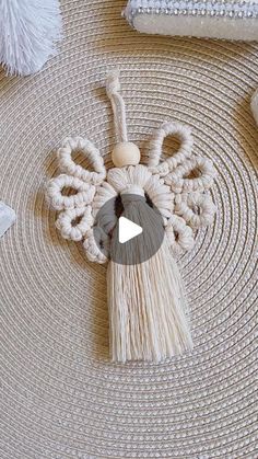 a video demonstrating how to make a woven angel ornament with tassels