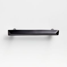 a black shelf mounted to the side of a wall