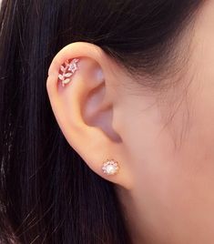 a close up of a person's ear with an earring on top of it