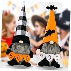 two halloween gnomes sitting next to each other