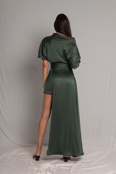 Word on the street is you want to stand out but still look chic. We’ve got you covered girl. The Fiore Dress is an asymmetrical dark sage green silk number, with a cowl neckline and ruched waist detailing. It means business on the right side and party on the left. It takes us 15 hours to make this dress. Check out the pricing transparency HERE. PLEASE ALLOW 1-3 BUSINESS DAYS FOR PRODUCTION Silk Asymmetrical Draped Dress With Ruched Detail, Chic Evening Satin Dress With Side Slits, Chic Satin Evening Dress With Side Slits, Sleek Draped Dress With Satin Finish, Asymmetrical Satin Draped Dress, Evening Satin Silk Dress With Side Slits, Chic Draped Satin Dress With Bias Cut, Asymmetrical Satin Dress For Date Night, Sleek Draped Satin Dress