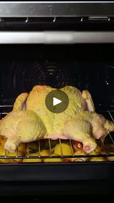 a chicken is being cooked in an oven