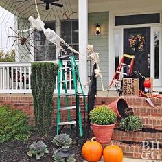 a porch decorated for halloween with pumpkins and decorations